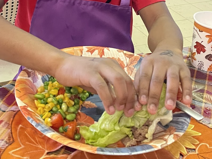 Syleem Davis Carefully Rolls His Turkey Lettuce Wrap
